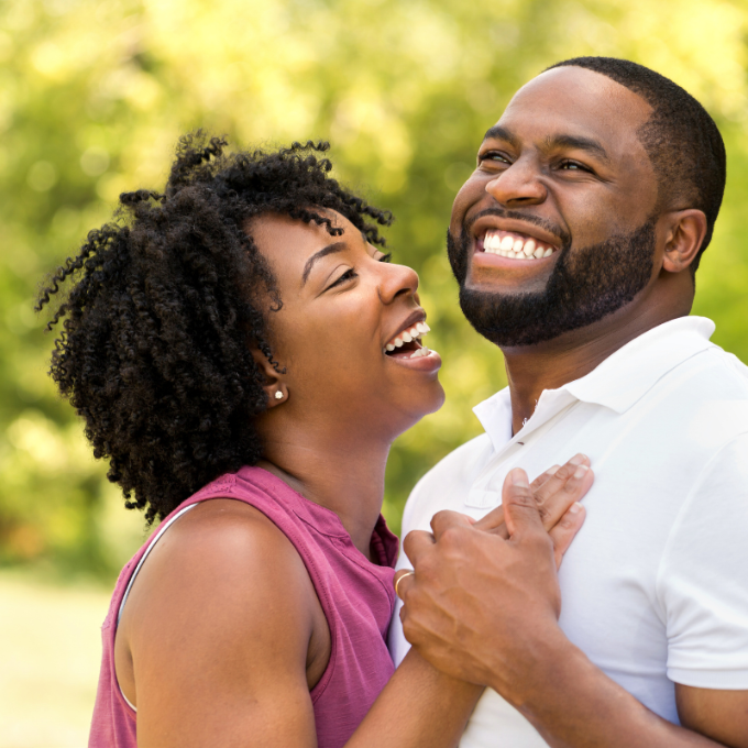 couple smiling outside 